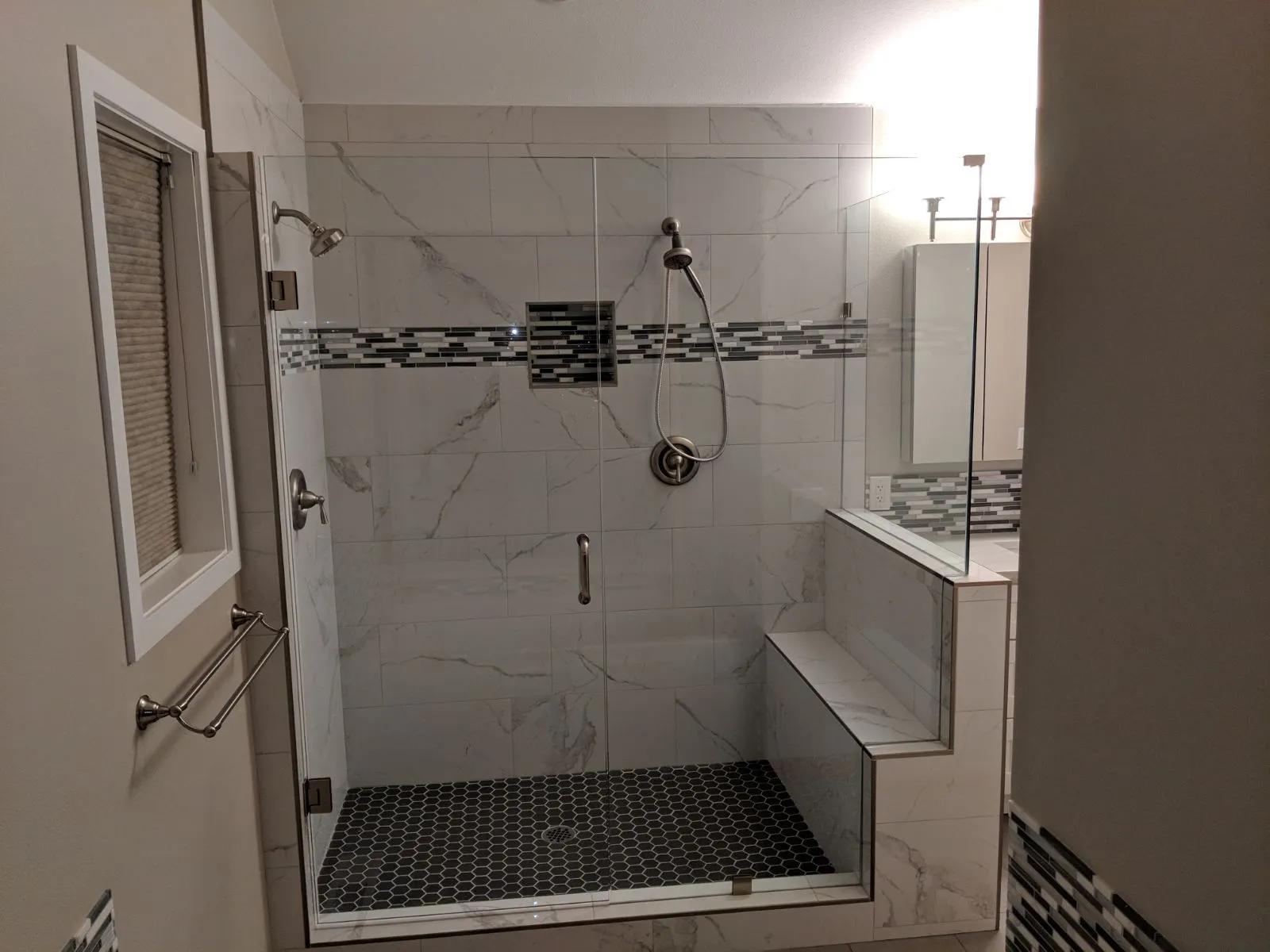 Walk-in tile shower with built-in niche shelving by Master Craft