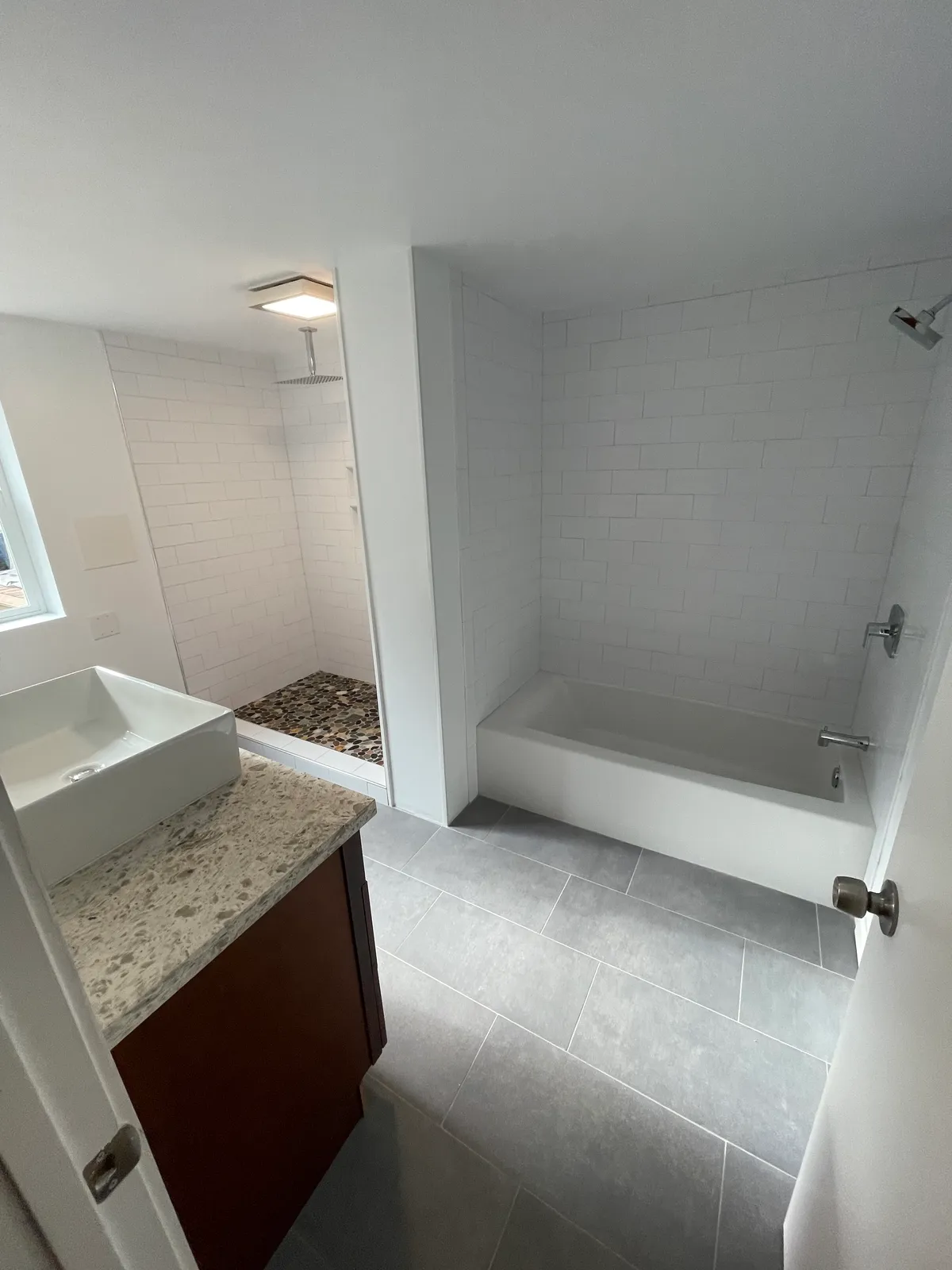 Bright, fully tiled bathroom remodel